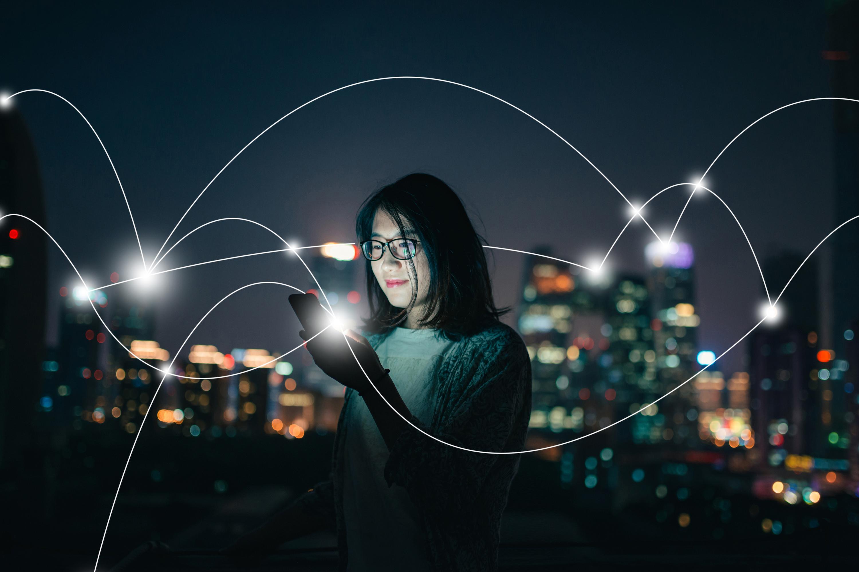 woman looking at phone networking